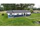 A charming one-story home with a crisp white exterior and a contrasting navy blue base with lush green lawn at 751 Northbrook Iii School Rd, Vale, NC 28168
