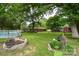 Backyard features an above ground pool, outbuilding and a fire pit for outdoor enjoyment at 7518 Surry Ln, Indian Trail, NC 28079