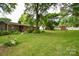 Large backyard features outbuilding, mature trees and plenty of green space at 7518 Surry Ln, Indian Trail, NC 28079