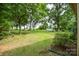 Expansive backyard with mature trees and partial view of the above ground pool at 7518 Surry Ln, Indian Trail, NC 28079