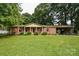 Charming brick ranch home with a welcoming front porch and well-manicured lawn at 7518 Surry Ln, Indian Trail, NC 28079