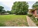 A large and well maintained front yard is beautifully landscaped with mature trees at 7518 Surry Ln, Indian Trail, NC 28079
