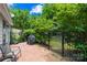 Private backyard with brick patio, lush greenery, and a tranquil outdoor space for gatherings at 7528 Red Oak Ln, Charlotte, NC 28226