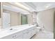 Well-lit bathroom featuring a double sink vanity and a separate toilet area at 7528 Red Oak Ln, Charlotte, NC 28226