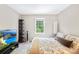 Bedroom featuring a mounted TV, decorative shelving unit, and a large window at 7528 Red Oak Ln, Charlotte, NC 28226