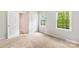 Bright, carpeted bedroom featuring two windows and closet access at 7528 Red Oak Ln, Charlotte, NC 28226