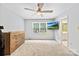 Bright bedroom featuring a ceiling fan and large window with a mounted TV at 7528 Red Oak Ln, Charlotte, NC 28226