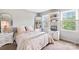 Cozy bedroom with decorative shelf, large mirror, and natural light at 7528 Red Oak Ln, Charlotte, NC 28226