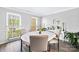 Bright dining room with a round white table, four chairs, and large windows offering natural light at 7528 Red Oak Ln, Charlotte, NC 28226