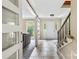Bright foyer with tile flooring, an open staircase, and modern sliding doors leading to the living room at 7528 Red Oak Ln, Charlotte, NC 28226