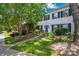 Beautiful townhouse featuring lush landscaping, a well-manicured lawn, and classic black shutters at 7528 Red Oak Ln, Charlotte, NC 28226