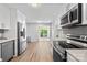 Bright kitchen featuring stainless steel appliances, granite countertops, and wooden floors at 7528 Red Oak Ln, Charlotte, NC 28226