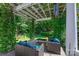 Relaxing deck space with a pergola covered in vines and comfortable outdoor furniture at 8109 Hawk Crest Ct, Charlotte, NC 28270