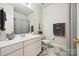 Well-lit bathroom featuring white vanity, tile floors, and a neutral color palette at 8109 Hawk Crest Ct, Charlotte, NC 28270