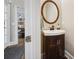 Elegant powder room showcasing a wood vanity with a vessel sink and a round mirror at 8109 Hawk Crest Ct, Charlotte, NC 28270
