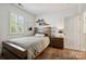 Cozy bedroom featuring a platform bed, hardwood floors, and bright natural light at 8109 Hawk Crest Ct, Charlotte, NC 28270