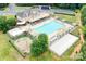 Aerial view of a sparkling community pool and clubhouse with lounge seating and recreational areas at 8109 Hawk Crest Ct, Charlotte, NC 28270