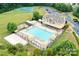 Aerial view of a community pool and clubhouse featuring a pool, sand volleyball, and sunning spaces at 8109 Hawk Crest Ct, Charlotte, NC 28270