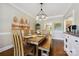 Stylish dining room with wood table, modern chandelier, and large window at 8109 Hawk Crest Ct, Charlotte, NC 28270