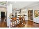 Bright open kitchen with a central island, hardwood floors, and white cabinets connecting to other living spaces at 8109 Hawk Crest Ct, Charlotte, NC 28270