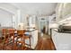 Open kitchen design with a central island, hardwood floors, white cabinetry, and stainless steel appliances at 8109 Hawk Crest Ct, Charlotte, NC 28270