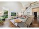 Bright living room with hardwood floors, comfortable seating, and scenic window views at 8109 Hawk Crest Ct, Charlotte, NC 28270