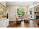 Inviting living room with large window offering serene views, fireplace, hardwood floors, and comfortable seating at 8109 Hawk Crest Ct, Charlotte, NC 28270