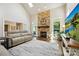 Cozy living room with a stone fireplace, large windows, and comfortable seating at 8109 Hawk Crest Ct, Charlotte, NC 28270