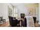 Cozy living room features hardwood floors, comfortable seating, a fireplace, and ample natural light from shuttered windows at 8109 Hawk Crest Ct, Charlotte, NC 28270