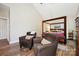 Light and airy main bedroom featuring vaulted ceilings, hardwood floors, and a four-poster canopy bed at 8109 Hawk Crest Ct, Charlotte, NC 28270