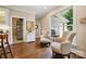 Bright sitting room with hardwood floors, natural light and comfortable seating by a large window at 8109 Hawk Crest Ct, Charlotte, NC 28270