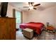 Cozy bedroom features a ceiling fan and a large window providing natural light at 812 Kings Rd, Shelby, NC 28150