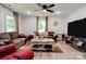 Comfortable living room featuring wood-look flooring, a ceiling fan, and natural light at 812 Kings Rd, Shelby, NC 28150