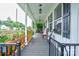 Inviting covered porch showcasing ample space for seating and relaxation with classic pendant lighting at 812 Kings Rd, Shelby, NC 28150