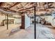 Unfinished basement offers potential for customization and expansion with exposed ceiling and concrete floor at 8255 Castor Rd, Salisbury, NC 28146