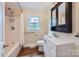 Cozy bathroom features a shower-tub combo, tile floors, and modern vanity at 8255 Castor Rd, Salisbury, NC 28146