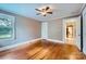 Bedroom features hardwood floors, neutral walls, large windows, and ample natural light at 8255 Castor Rd, Salisbury, NC 28146