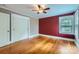 Bright bedroom with hardwood floors, ceiling fan, and natural light from the window at 8255 Castor Rd, Salisbury, NC 28146