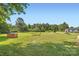 Wide-open grass-covered front yard featuring mature trees and an outbuilding in a serene setting at 8255 Castor Rd, Salisbury, NC 28146