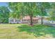 Quaint home featuring a red roof, attached two-car garage, and a lush green lawn at 8255 Castor Rd, Salisbury, NC 28146