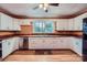 Well-lit kitchen with white cabinets, a stainless steel dishwasher, and a view from above at 8255 Castor Rd, Salisbury, NC 28146