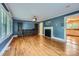 Spacious living room boasting hardwood floors, a cozy fireplace, and built-in bookshelves at 8255 Castor Rd, Salisbury, NC 28146