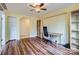 Sunny home office with hardwood floors and built-in shelving at 8255 Castor Rd, Salisbury, NC 28146