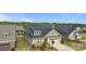 Stunning aerial view of a home featuring a well-maintained lawn, mature trees, and a spacious two-car garage at 9435 Liberty Hill Dr, Mint Hill, NC 28227