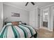 Bedroom with striped bedding, ceiling fan, and an ensuite bathroom at 9435 Liberty Hill Dr, Mint Hill, NC 28227