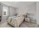 Serene bedroom with neutral tones, a window letting in natural light, and stylish lamps on the nightstands at 9435 Liberty Hill Dr, Mint Hill, NC 28227