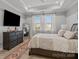 Bright bedroom featuring a trey ceiling, a large window, and neutral decor at 9435 Liberty Hill Dr, Mint Hill, NC 28227