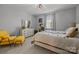 Bright bedroom featuring a comfy chair, dresser, a window with natural light, and a bed with stylish bedding at 9435 Liberty Hill Dr, Mint Hill, NC 28227