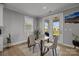 Dining room featuring a glass-top table, four chairs, neutral walls, and a view of the backyard at 9435 Liberty Hill Dr, Mint Hill, NC 28227