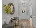 Welcoming foyer with light wood flooring, neutral walls, elegant console table, and decorative mirror at 9435 Liberty Hill Dr, Mint Hill, NC 28227
